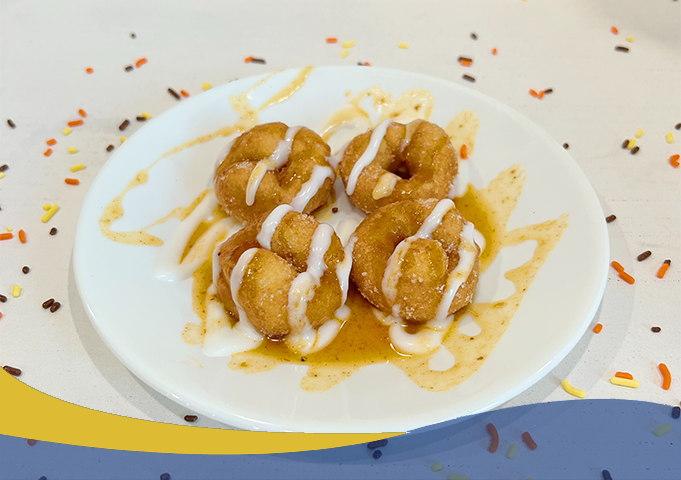 A plate of donuts with syrup drizzle
