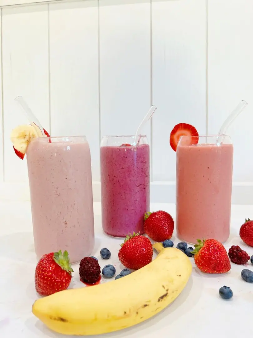 Three glasses of smoothies with mixed berries